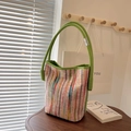 Colorful striped knit bucket bag with vibrant lime green handles and metallic hardware - Green