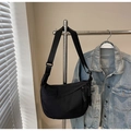 Detailed view of black nylon crescent moon bag with wide strap and rope zipper pulls - Black