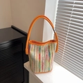 Colorful striped bucket bag with bright orange handles and stylish fabric texture - Orange