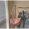 Detailed close-up of pink nylon hobo bag with distinctive rope woven zipper pull on a hanger - Pink