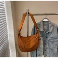 Detail of caramel nylon crescent bag featuring a woven rope zipper and wide strap - Brown