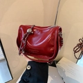 Glossy red patent leather shoulder bag with silver chain strap and metal nameplate - Red