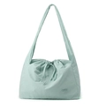 Detail of mint green nylon shoulder bag showing pleated texture and drawstring closure - Soft Mist Green