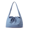 Detail of blue waterproof nylon handbag showing functional drawstring closure and fabric texture - Iris Blue