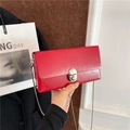 Vibrant red leather crossbody box bag with silver metal lock and chain strap for women - Red