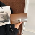 Brown leather rectangular crossbody bag with silver twist lock and delicate metal chain strap - Brown
