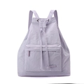 Detail of light purple drawstring backpack featuring front zipper pocket and nylon texture - Lavender