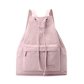 Detail of light pink drawstring backpack featuring nylon texture and front zipper pocket - Peach Pink