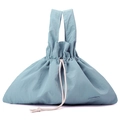 Detail of grey-blue nylon handbag featuring a drawstring closure and cream cotton rope handles - Haze Blue