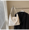 Détail d'un sac hobo blanc brillant avec boucle argentée suspendu à un cintre en métal - Blanc Cassé (Sans Pendentif)