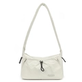 Detailed macro of the water-resistant nylon fabric texture and drawstring on the cream bag - Bone White