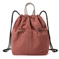 Detail of dusty pink drawstring backpack featuring nylon fabric and adjustable front pocket - Berry Red