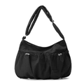 Detailed macro view of the pleated nylon texture and drawstring pocket on the black cloud bag - Ink Black