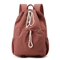 Detail of large capacity brick red nylon drawstring backpack with front pocket and side pockets - Berry Red