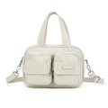 Detail of light beige nylon utility handbag with front zipper pockets and silver hardware - Bone White