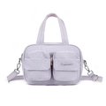 Detail view of lavender multi-pocket crossbody bag in water-resistant nylon material - Lavender