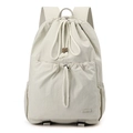 Detail view of large nylon drawstring backpack with front pocket and side compartments - Bone White
