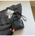 Black embossed bucket bag with floral butterfly patterns and adjustable strap - Black (Without Charm)