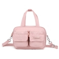 Detail of pink waterproof nylon crossbody bag featuring double front flap pockets - Peach Pink