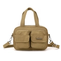 Detail of multi-pocket khaki nylon crossbody bag showing zippers and brand logo tag - Earthy Yellow
