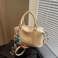 Creamy white Boston bag with embossed lettering and adjustable long shoulder strap - Cream White With Pendant