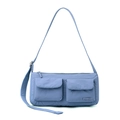 Detail of light blue nylon messenger bag featuring waterproof fabric and two front pockets - Iris Blue