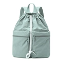 Macro detail of mint green nylon drawstring backpack with front zippered pockets - Soft Mist Green