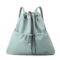 Detail of mint green nylon drawstring backpack featuring adjustable straps and front pocket - Soft Mist Green
