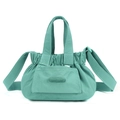Detail view of mint green nylon crossbody bag with pleated closure and wide strap - Azure Green