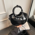 Polished black leather half-moon handbag with circular top handle and long strap - Black