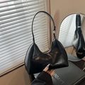 Chic black glossy faux leather hobo shoulder bag with silver zipper and sleek curves - Black