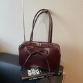 Minimalist large-capacity burgundy shoulder bag featuring a stylish bow and glossy leather finish - Coffee