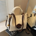 Cream tote bag with dark brown handles and adjustable strap in mirror reflection - With Charm / Off White