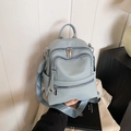 Light blue faux leather backpack with pebbled texture and functional multi-pocket design - Blue