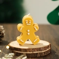 Gingerbread man scented candle with white details on a rustic wooden base - Ginger Yellow
