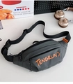 Flat lay of gray waterproof nylon chest bag with orange logo, headphones and magazine - Gray