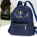 Close-up of litchi grain texture and gold kangaroo logo on a navy blue backpack - Blue