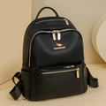 Close-up of black lychee grain faux leather backpack with gold metal zippers and logo - Black