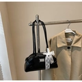 Detail of black leather dumpling bag with silver logo and white lace bow decoration - Black