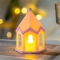 Pink house-shaped night light with LED candle and warm yellow glow for cozy home decor - Pink
