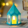 Mint green LED lantern with warm candle light on books for cozy room decor - Blue