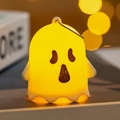 Detail showing cartoon Halloween ghost LED light with hanging ring and warm yellow glow - Surprised Ghost (D)