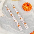 Pair of white Halloween taper candles featuring festive pumpkin and bat print patterns - Ghost Pumpkin / White