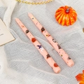 Detail view of 25cm pink Halloween taper candles with pumpkin and ghost illustrations - Skull Bat / Pink