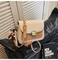 Detail of color-block flap bag with golden twist lock, pearl chain, and mascot charm - Khaki with Pendant