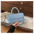 Close-up of a light blue rectangular crossbody bag with a silver buckle and top handle - Blue