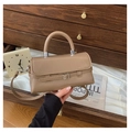 Detail of khaki PU leather crossbody bag with metal buckle on a rustic wooden drawer - Khaki