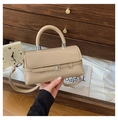 Detail of a beige PU leather crossbody bag with a round handle and matte finish - Apricot