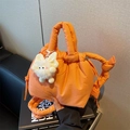 Bright orange quilted bucket bag with padded handle and white plush cat charm accessory - Orange With Pendant