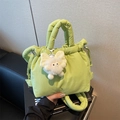 Quilted light green bucket bag with drawstring closure and a fuzzy monster pendant charm - Neon Green with Charm